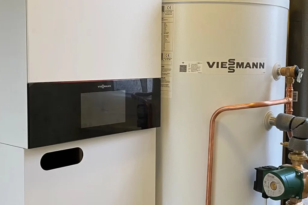 Viessmann boiler and hot water cylinder installed with copper pipework and heating pump.