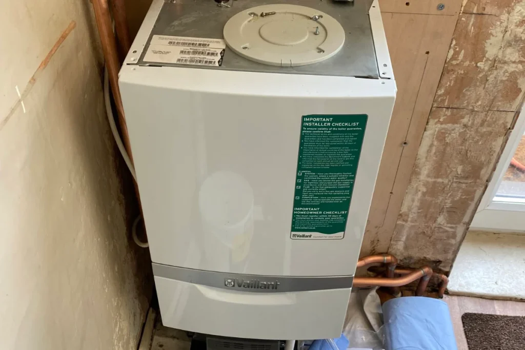 Vaillant floor-standing gas boiler with connected copper pipework and plumbing fittings in a residential property.